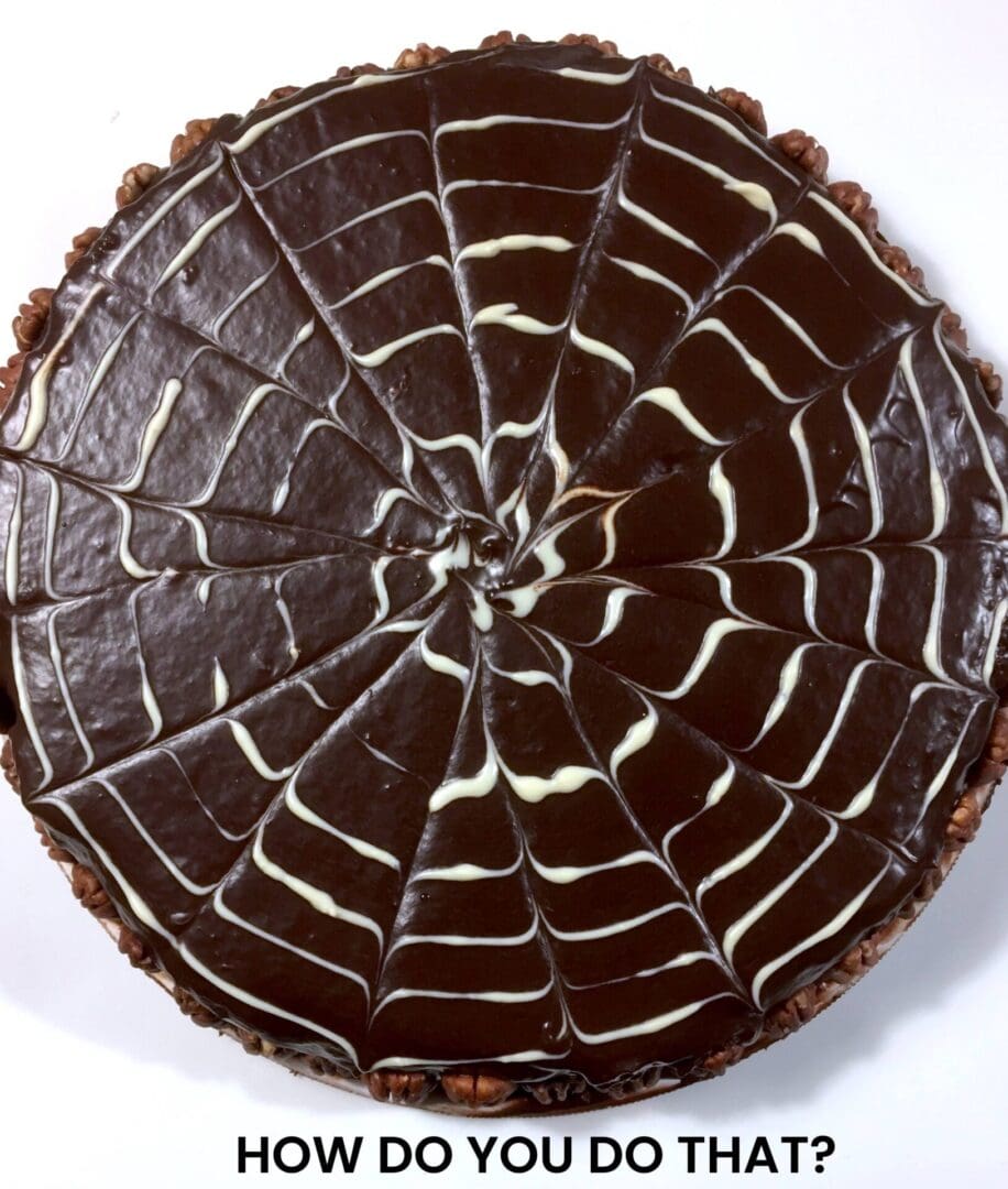 A Chocolate Cake With White Chocolate Design