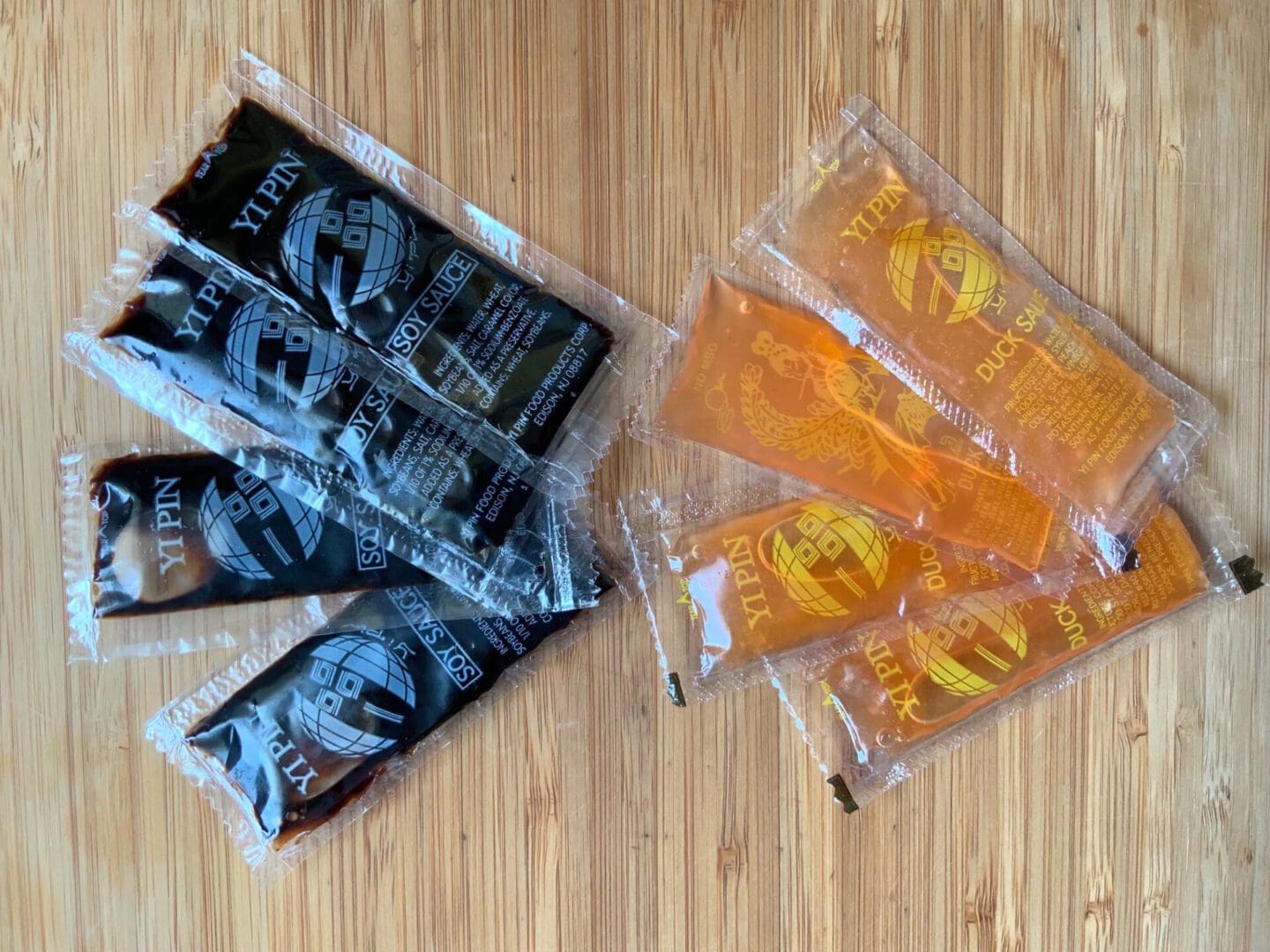 Packaged black and orange snack bars arranged on a wooden surface.