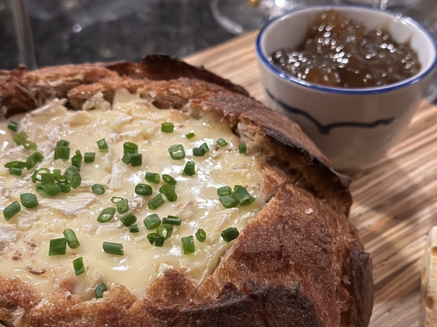 A Baked Pie With Cheese Top and Green Onion Topping