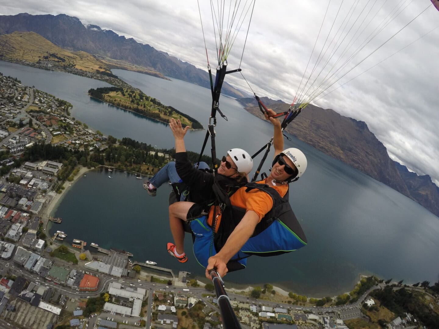 A skydiver flying in the air with a lady