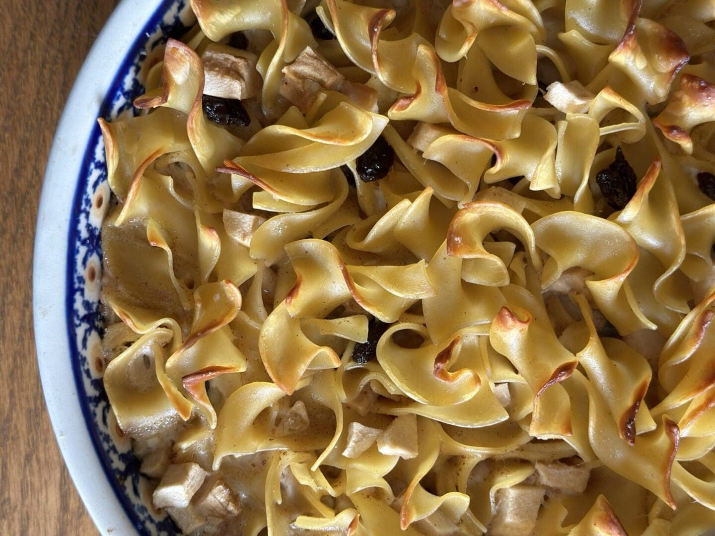 A dish of pasta with raisins and cranberries.
