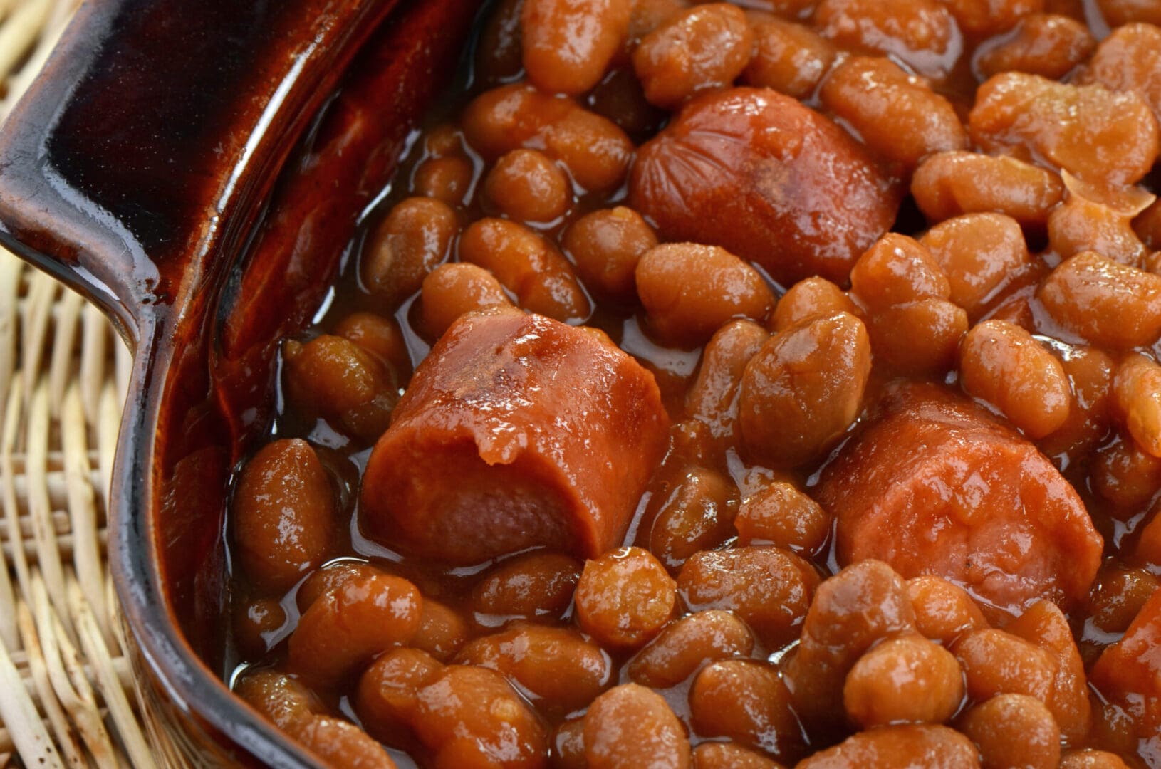 Baked beans with sausage in a bowl.