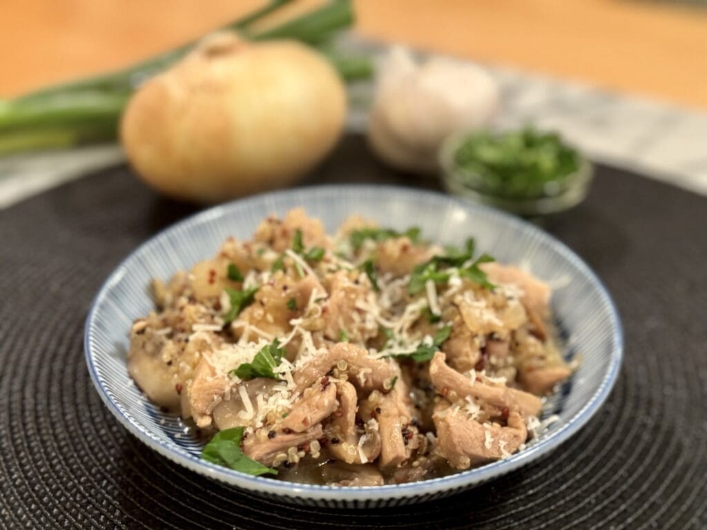 Chicken and quinoa dish with parsley garnish.