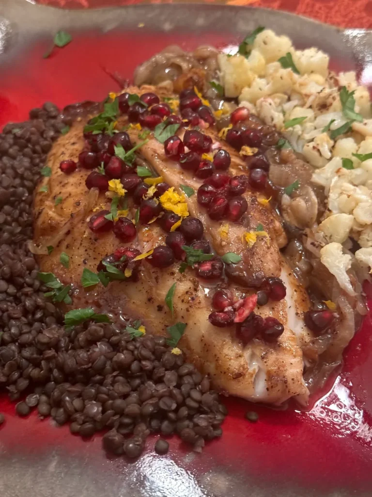 Fish with lentils, cauliflower, and pomegranate seeds.