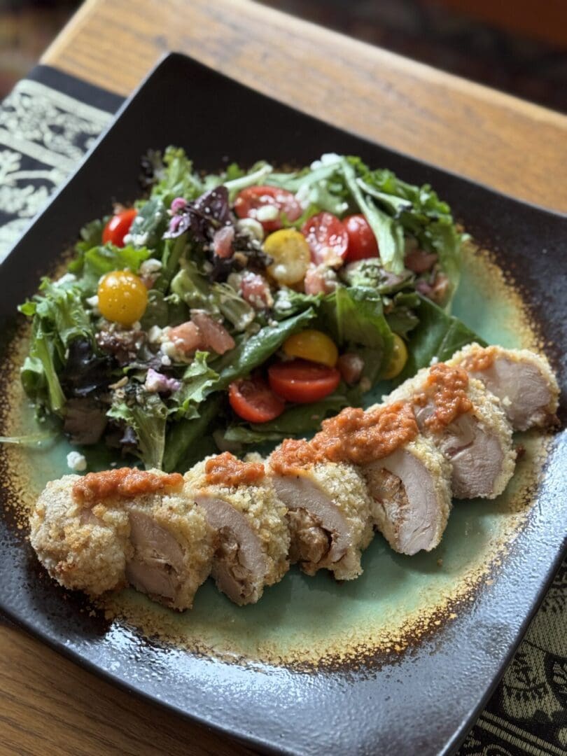 original Crispy chicken with fresh salad on plate.