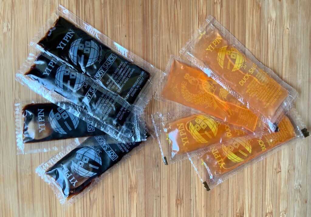 Packaged black and orange snack bars arranged on a wooden surface.