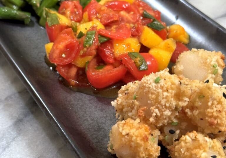 Fried seafood, tomato salad, and asparagus.