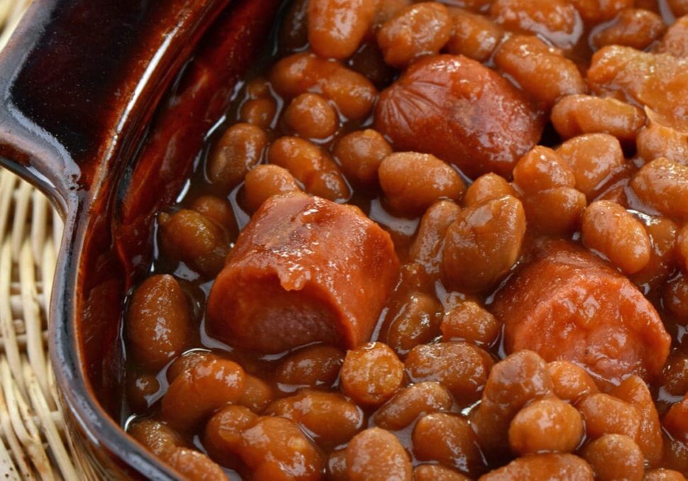 Baked beans with sausage in a bowl.