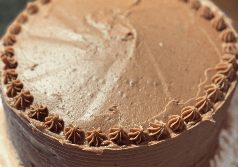 A chocolate orange raspberry cake on a plate.