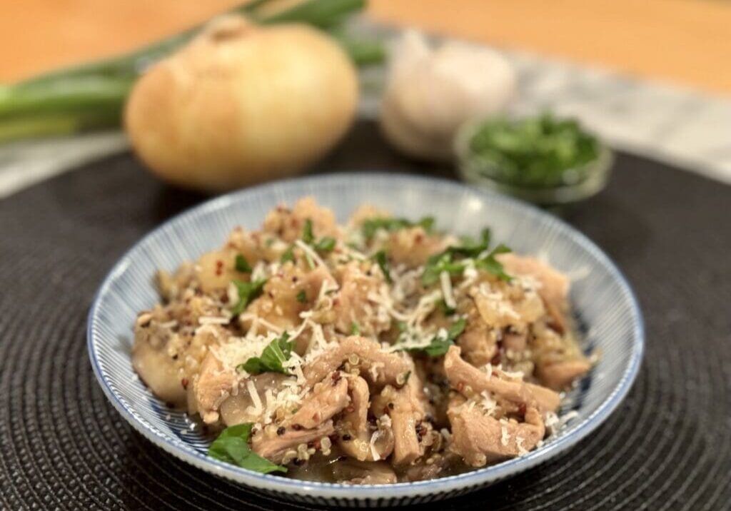 Chicken and quinoa dish with parsley garnish.