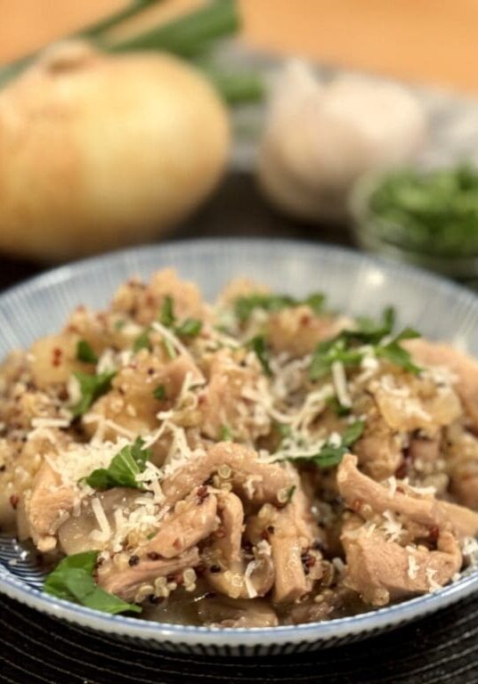 Chicken and quinoa dish with parsley garnish.