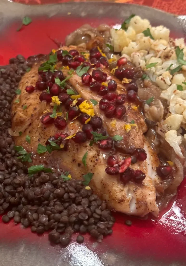 Fish with lentils, cauliflower, and pomegranate seeds.