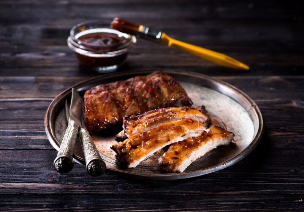 Barbecue glazed pork ribs on metal plate