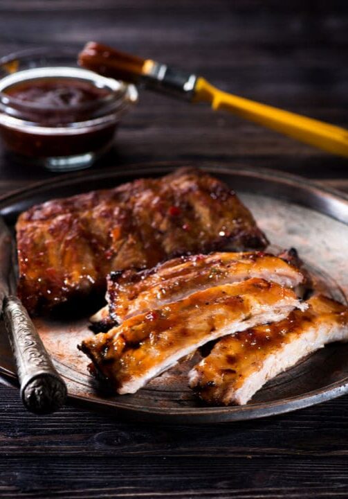 Barbecue glazed pork ribs on metal plate