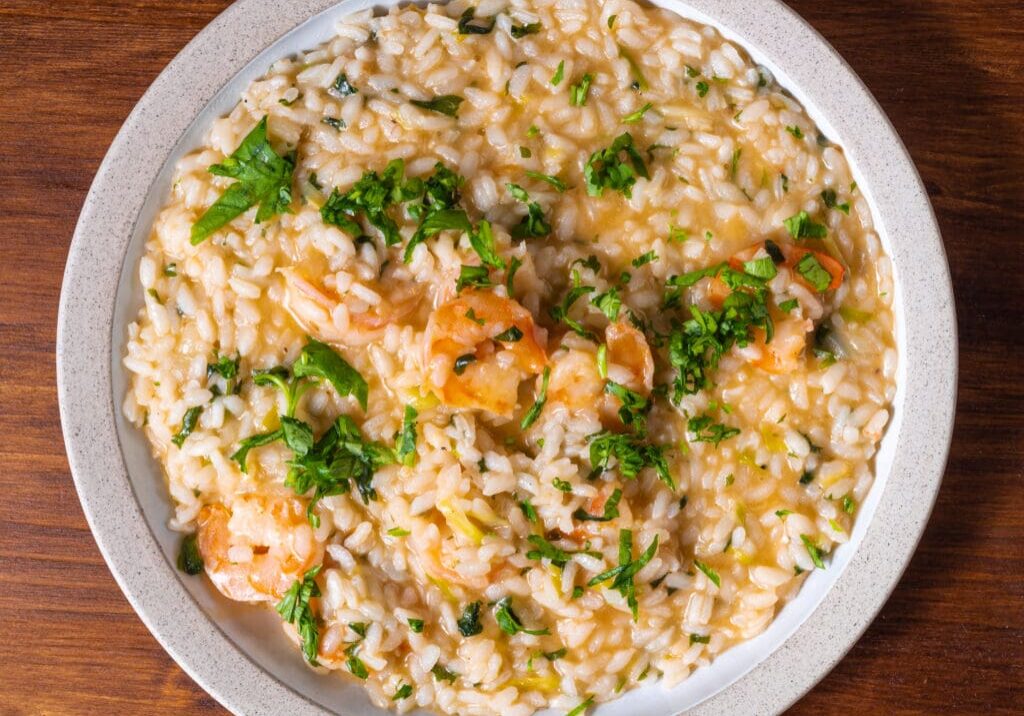 Shrimp risotto with parsley in a bowl.