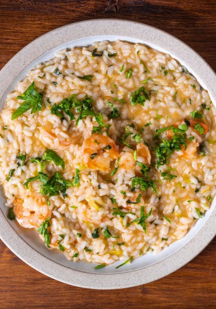 Shrimp risotto with parsley in a bowl.