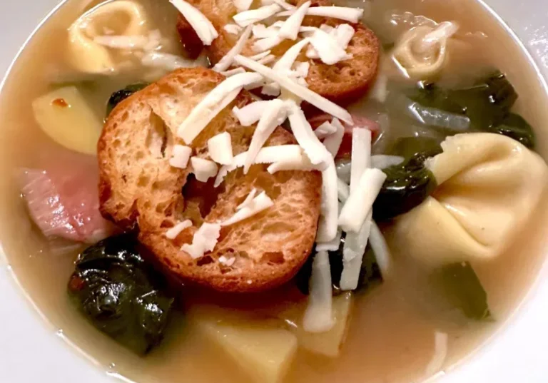 Tortellini soup with croutons and cheese.