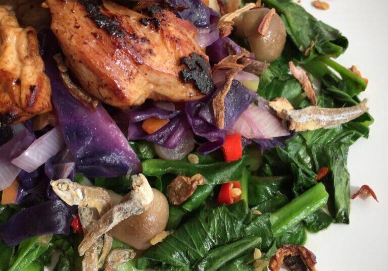 Close up shot of Asian Grilled Chicken Over Greens